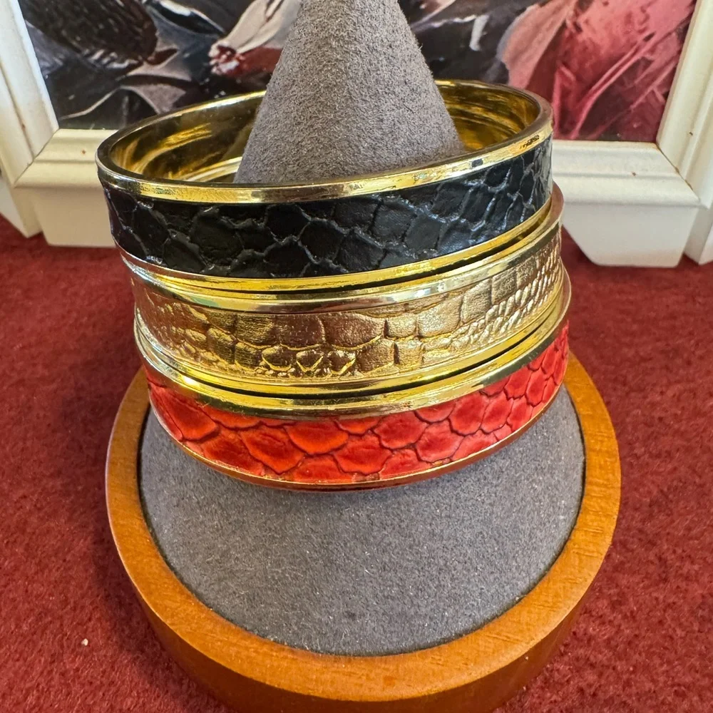 Set of gold tone bangles with inlaid faux croc leather